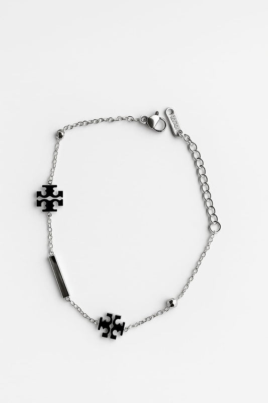 Silver bracelet with puzzle piece charms